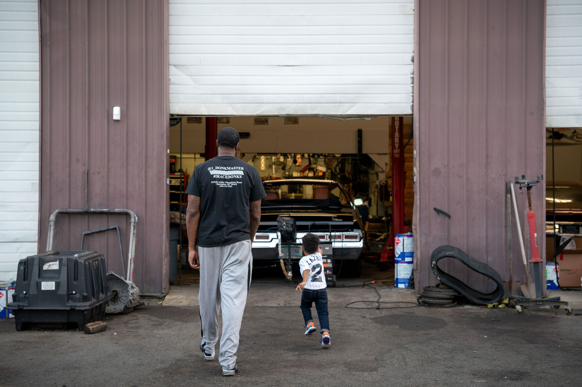 Donkmaster and son at his shop In and Out Customs
