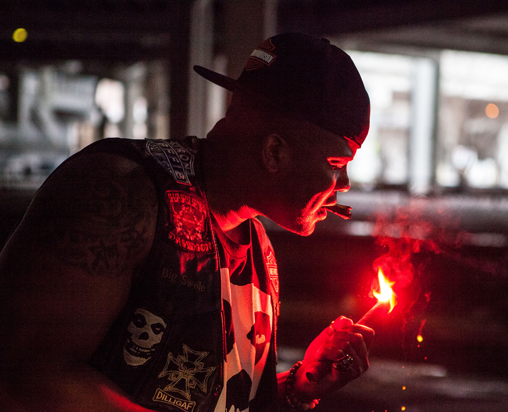 Big Swole lighting up his cigar during a Harley-Davidson photoshoot.