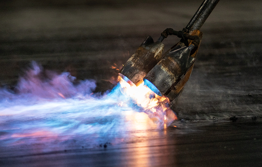 Hand scraper flame prepping the dragstrip for DONK Racing in Darlington